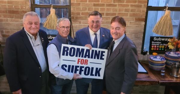 People holding Romaine for Suffolk sign.