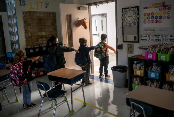  A kindergarten class socially distances while preparing to leave their classroom.