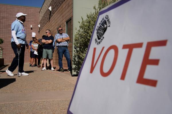 People wait in line to vote at a polling place on June 14, 2022, in Las Vegas.