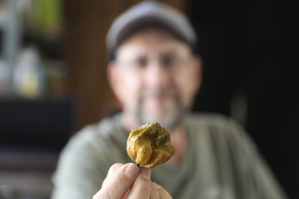 Ed Currie holds up one of his Pepper X chillies, the hottest in the world.